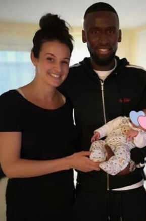 Laura Rudiger and Antonio Rudiger holding over their newly born baby.